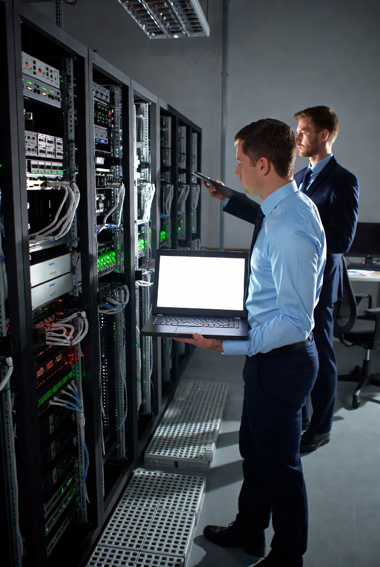 Edmonton IT technician providing IT support for small business owner in a modern office