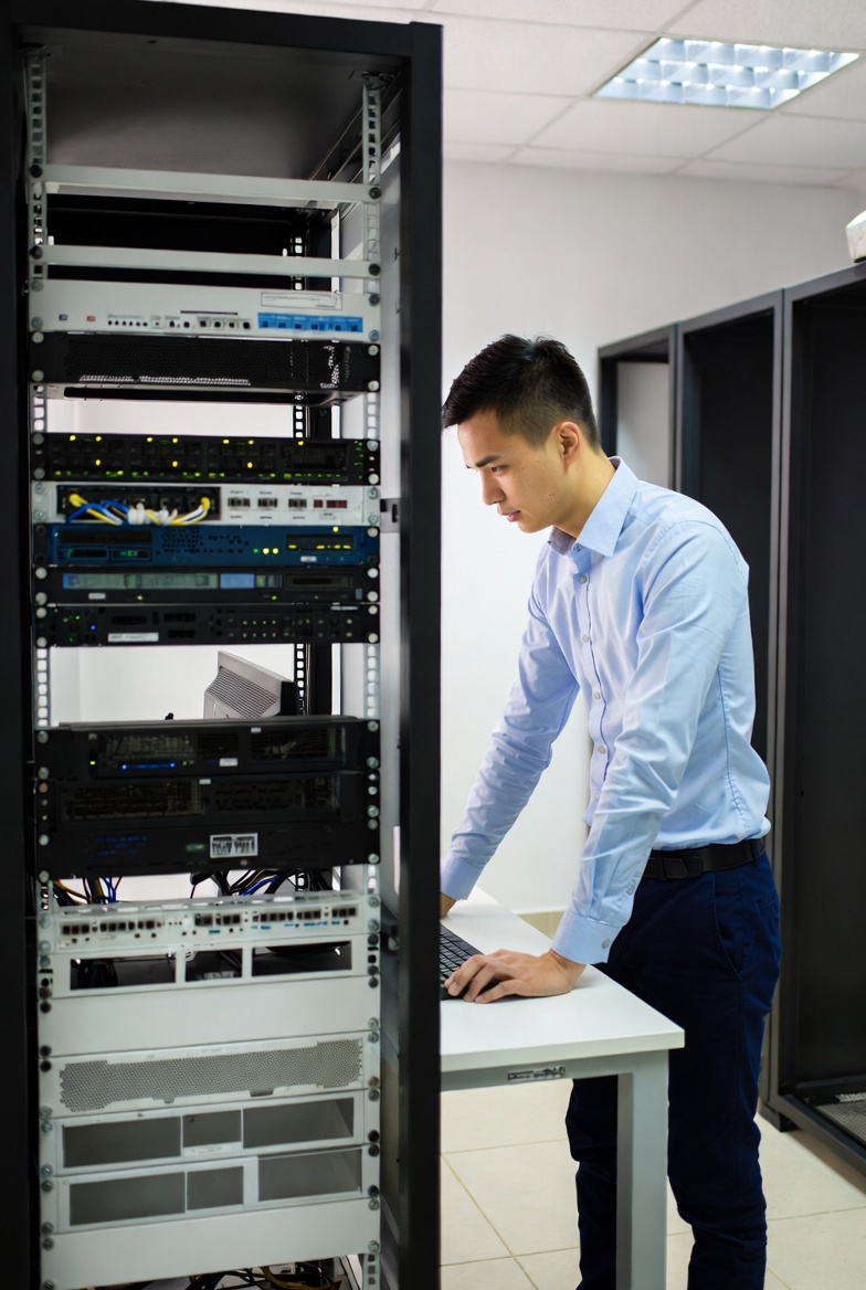 Edmonton IT technician setting up rugged laptop and secure network for a local construction job site